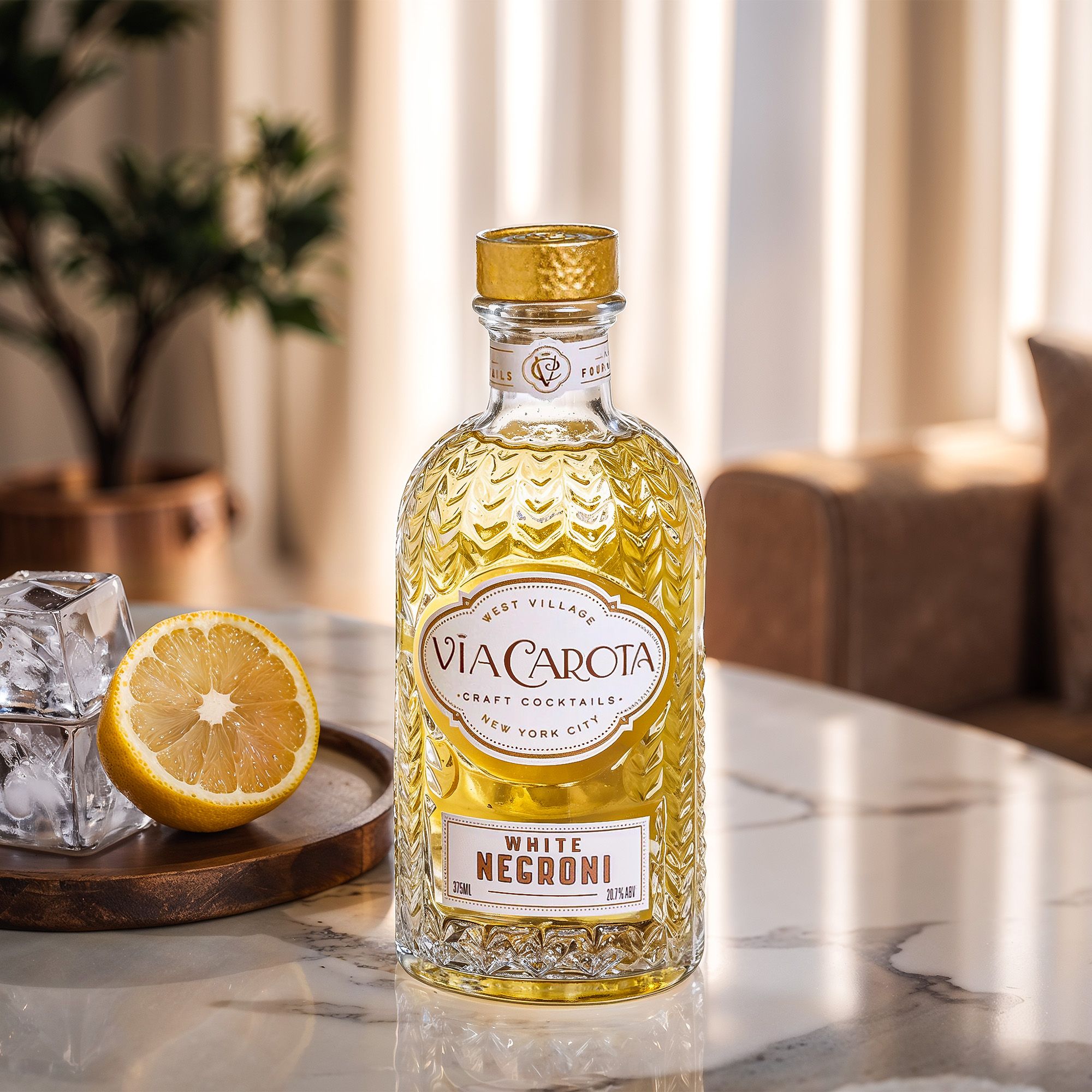 White Negroni bottle on a marble table with lemon and ice, curtains glowing behind — Chronos Studio.