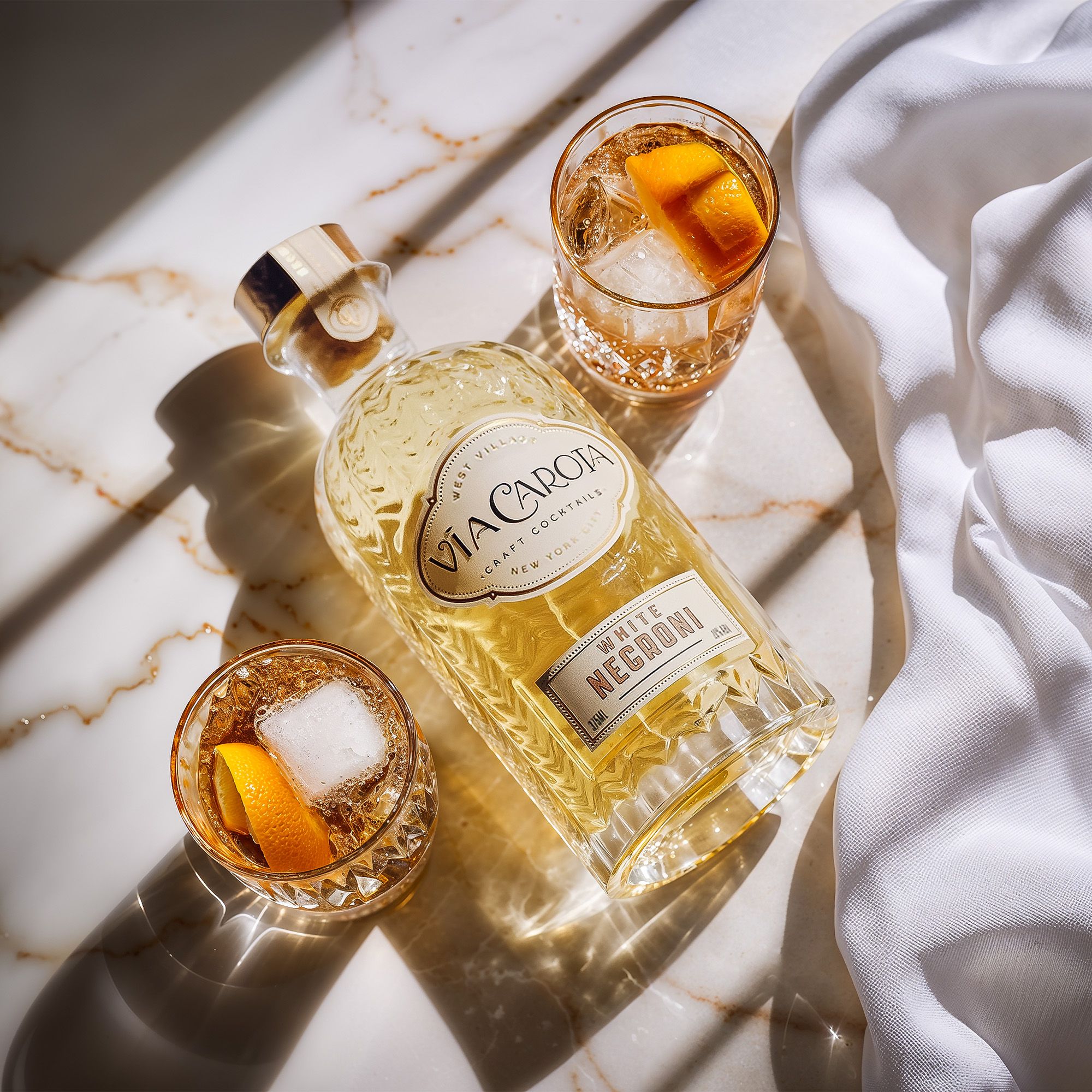 White Negroni flat lay on veined marble with two garnished glasses and linen — Chronos Studio.