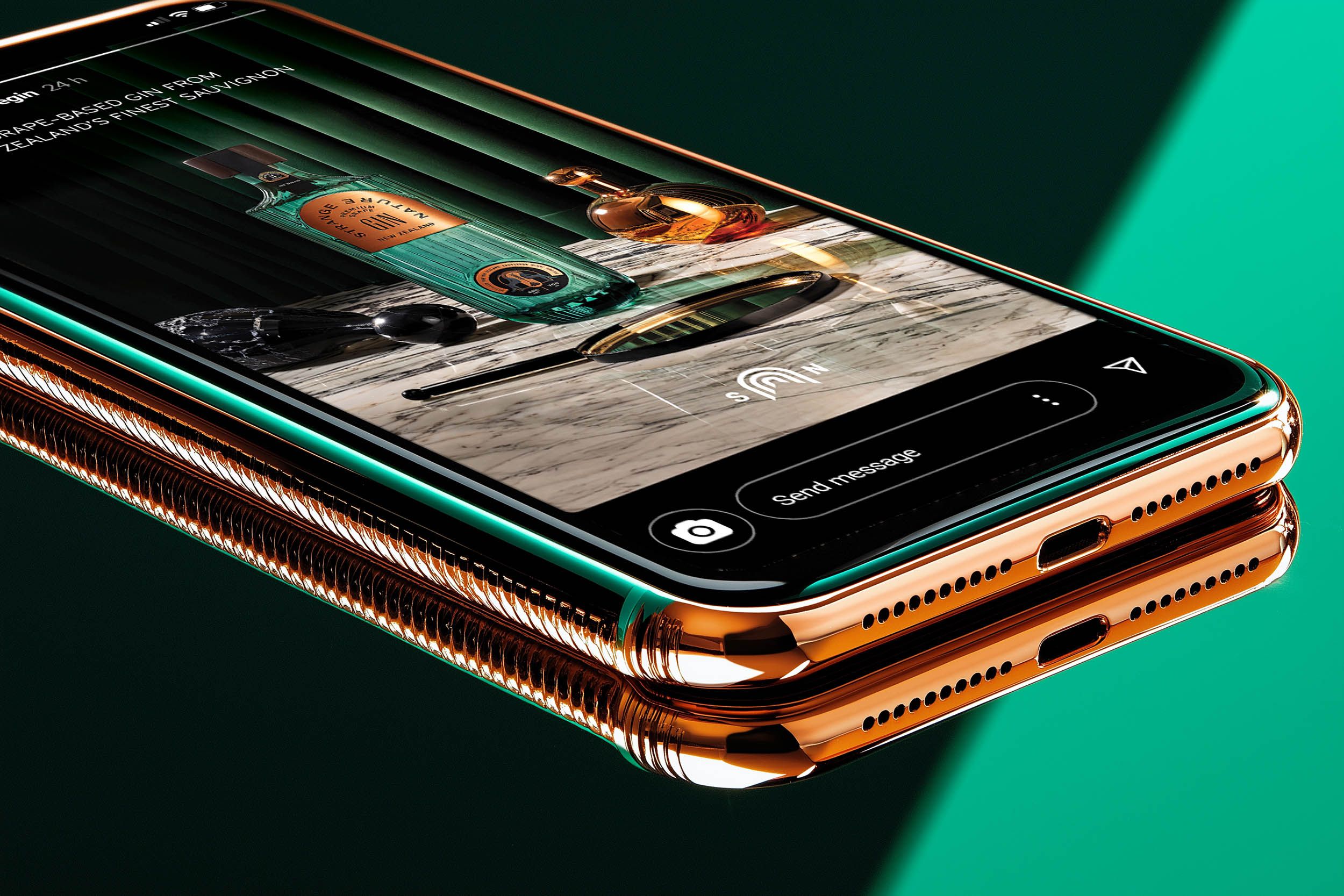 Gold smartphone lying on a split green backdrop, playing a Strange Nature Instagram story — social-first delivery by Chronos Studio.