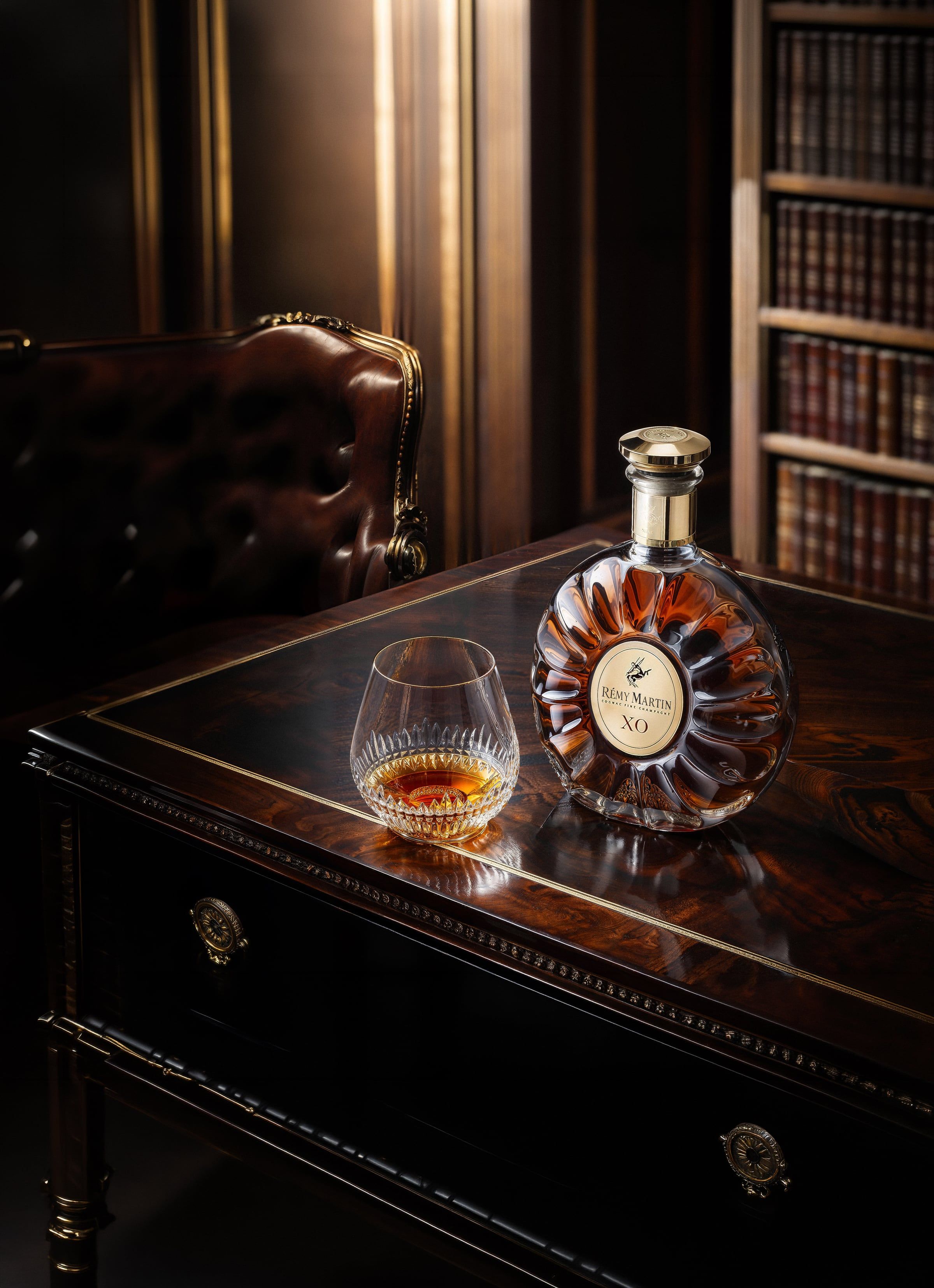 AI product photography of a cognac bottle on a dark editorial set — Chronos Studio.