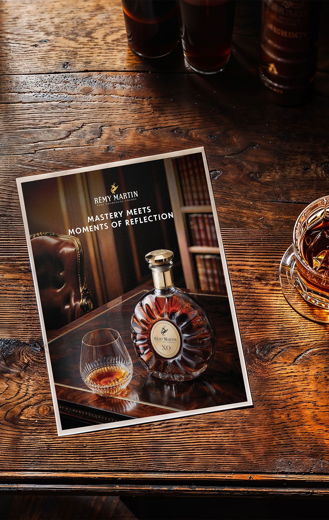 Tall frame of the XO bottle with cognac serve, heritage details in shadow — Chronos Studio.