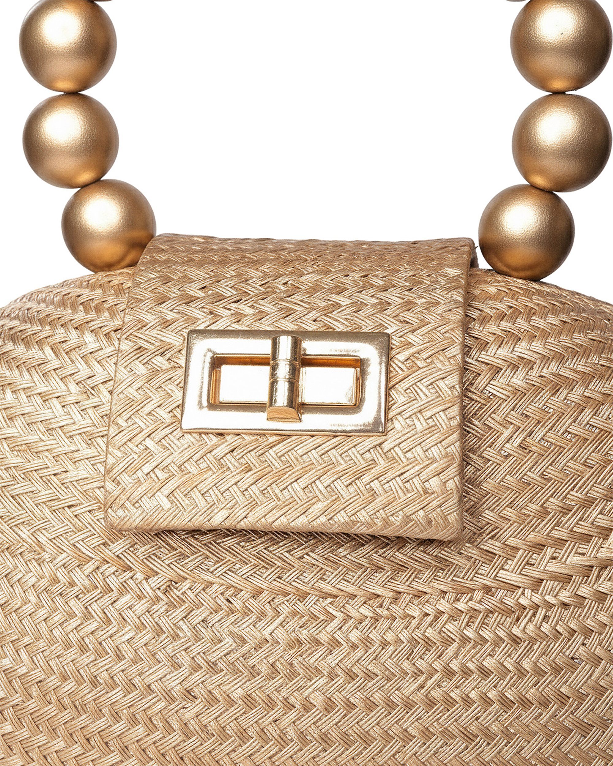 Artisan bag worn on the shoulder in a sunlit lifestyle scene — Chronos Studio.
