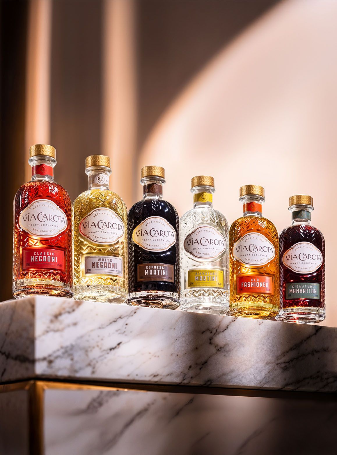 Via Carota craft cocktail bottle photographed on a warm editorial set — Chronos Studio.